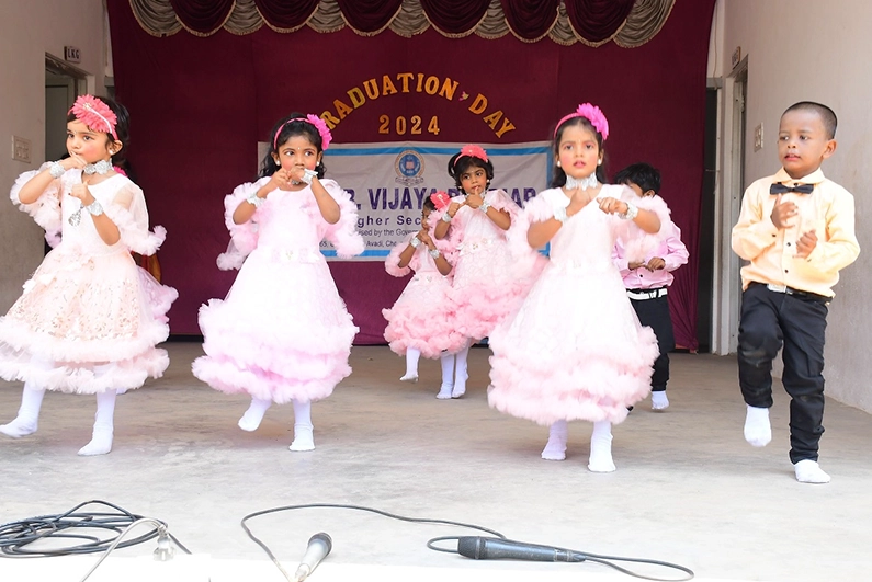 Kindergarten students of SBVR School, Avadi, performing a coordinated dance during a school event.