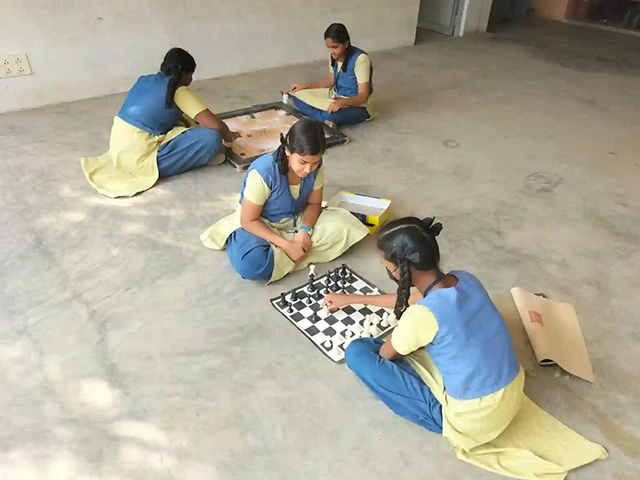 Students actively play chess indoors at SBVR School Avadi, improving focus, logic, strategic skills.
