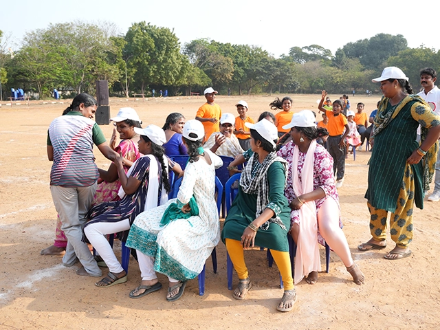 Teachers join students enthusiastically in outdoor activities, encouraging teamwork and motivation.