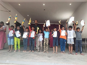 SBVR School students proudly displaying academic awards and achievements during a school ceremony.