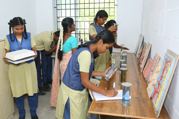Students performing a scientific experiment with modern equipment in SBVR School's advanced labs